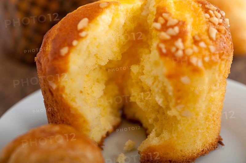 Fresh baked muffin and croissant mignon on old wood table
