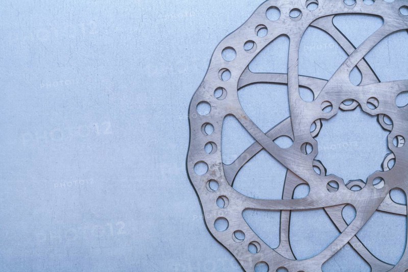 Metal gear wheel on flat metallic background Machine concept
