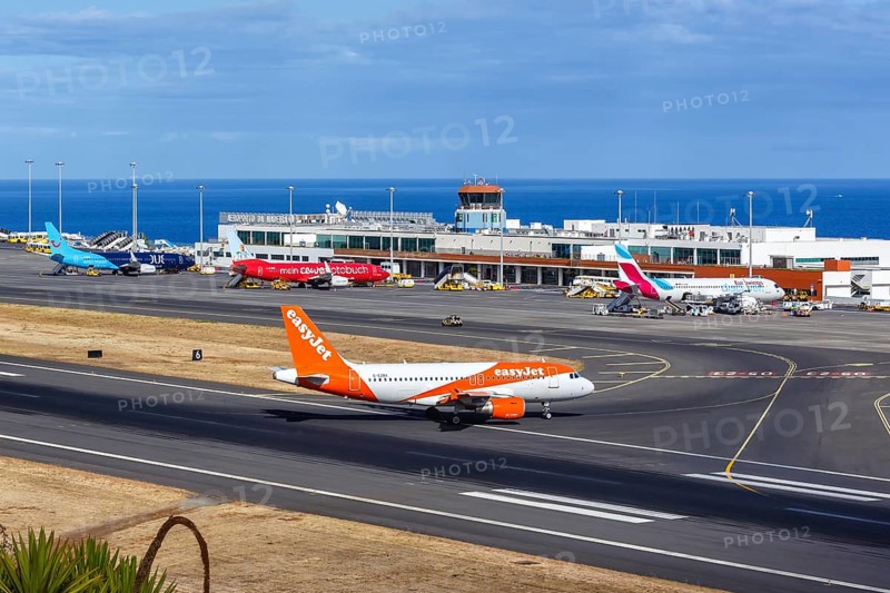 An EasyJet Airbus A319 aircraft with the registration G-EZBX at Funchal Airport