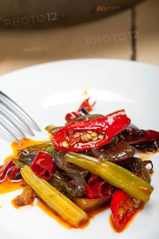 Fried chili pepper and vegetable on a iron wok pan
