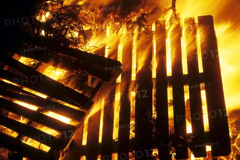 Wooden pallets in fire of huge bonfire during Christmas tree burning