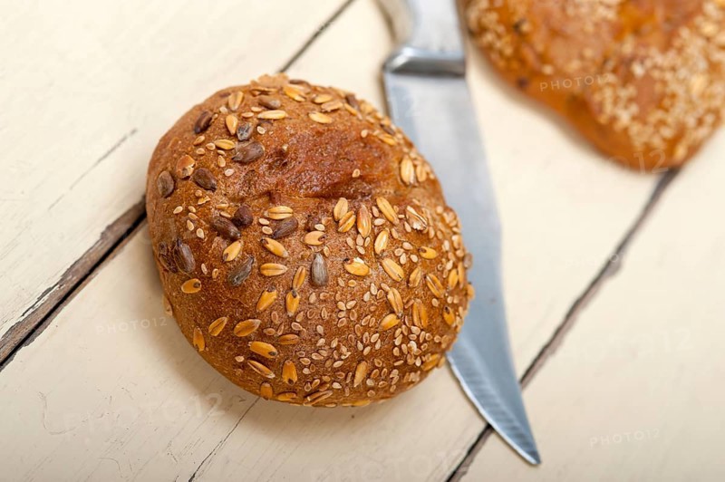 Fresh organic bread over rustic table macro closeup
