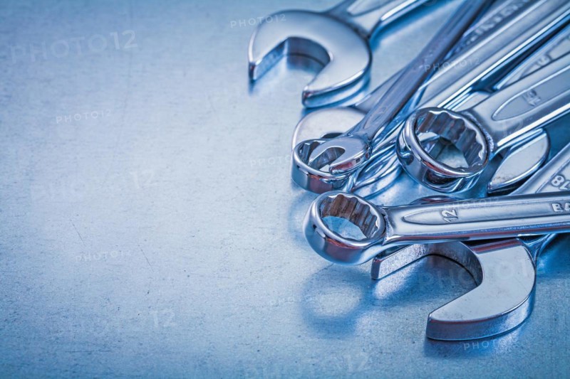 Vertical view of flat spanners and open-end spanners on a metallic background Repair concept