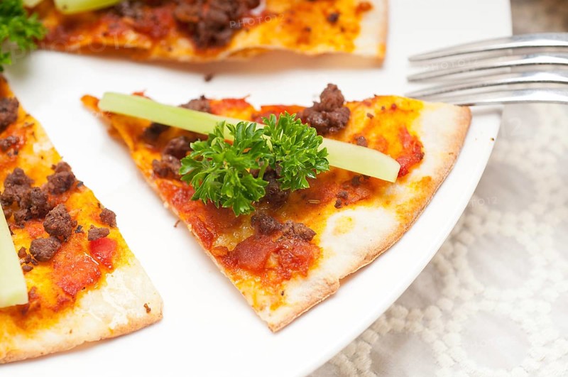 Fresh baked Turkish beef pizza with cucumber on top