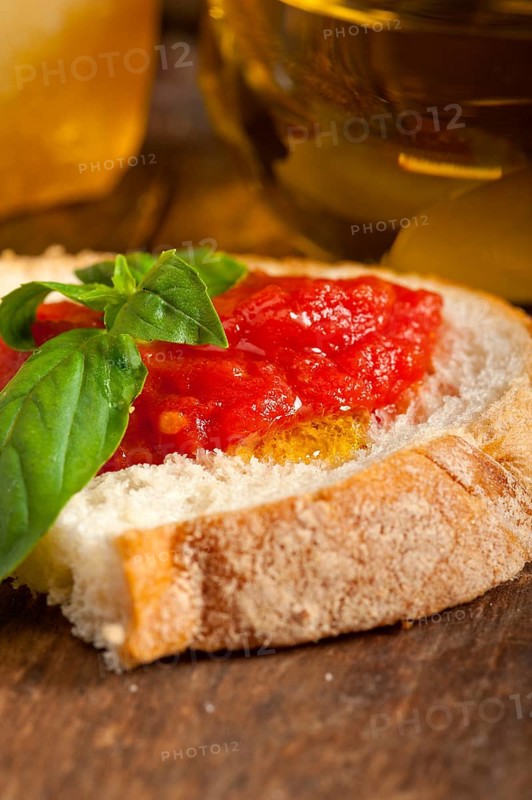 Italian fresh tomato and basil bruschetta with pecorino cheese over old wood