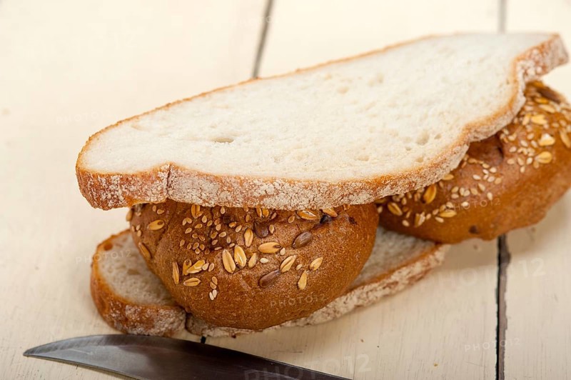 Fresh organic bread over rustic table macro closeup