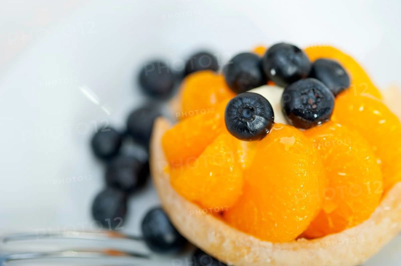 Fresh blueberry and tangerine orange cream cupcake homemade closeup macro