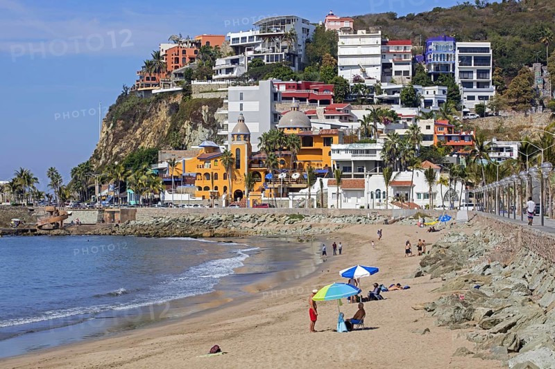 Tourists sunning on the beach along the Malecon