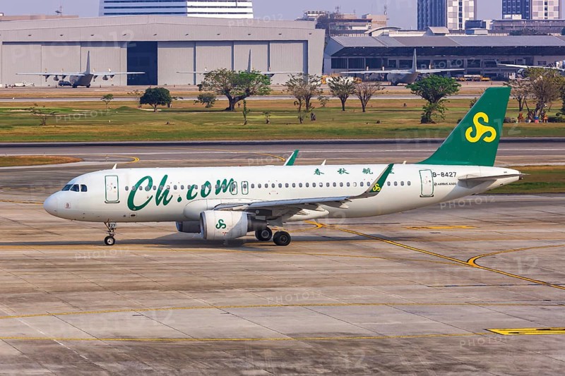 A Spring Airlines Airbus A320 aircraft with registration number B-8427 at Bangkok Don Mueang Airport
