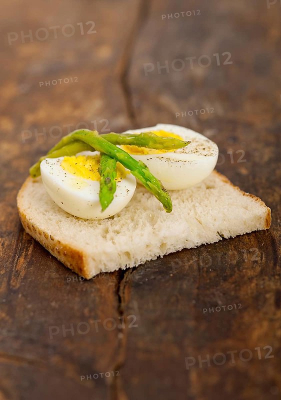 Boiled fresh green asparagus and eggs with extra virgin olive oil with rustic bread