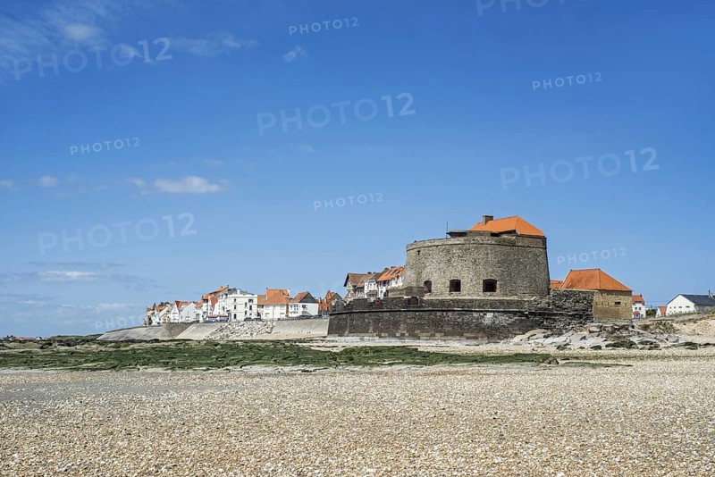 Fort Mahon and shingle beach at low tide at Ambleteuse along rocky North Sea coast