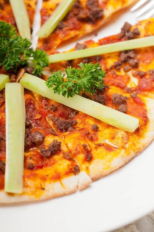 Fresh baked Turkish beef pizza with cucumber on top