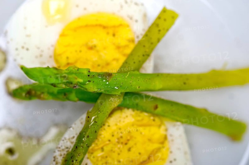 Boiled fresh green asparagus and eggs with extra virgin olive oil