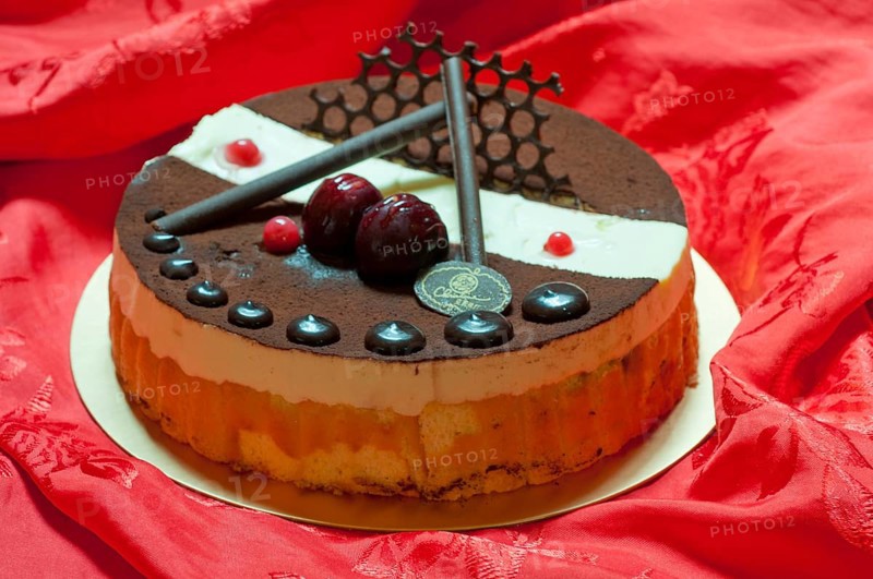 Chocolate birthday cake over red fabric background