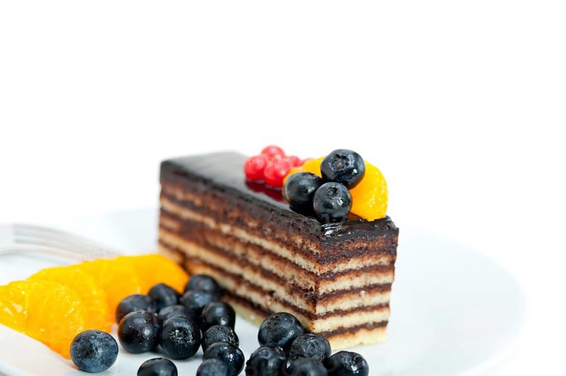 Chocolate cake and fresh fruit on top closeup macro