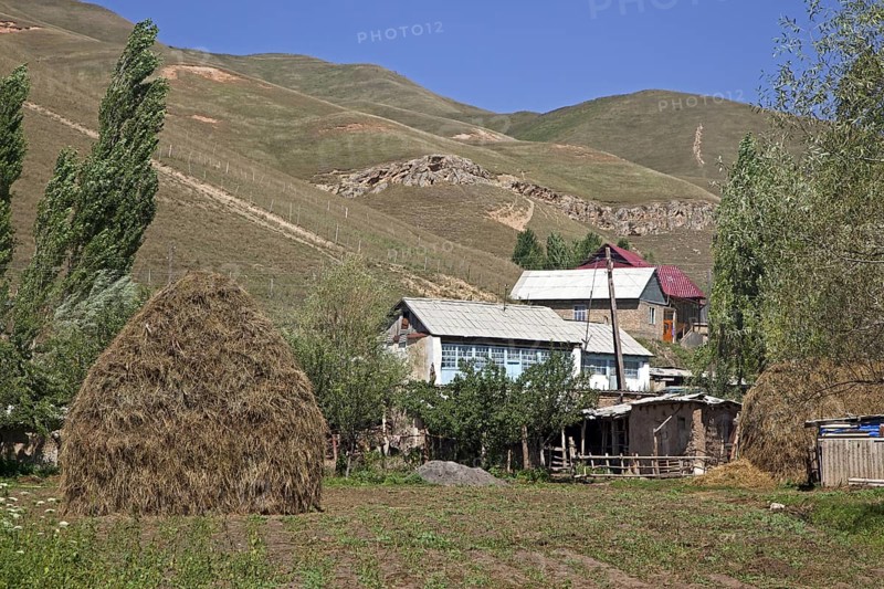 Haystack in field near rural Kyrgyz village in the mountains in the Osh Province