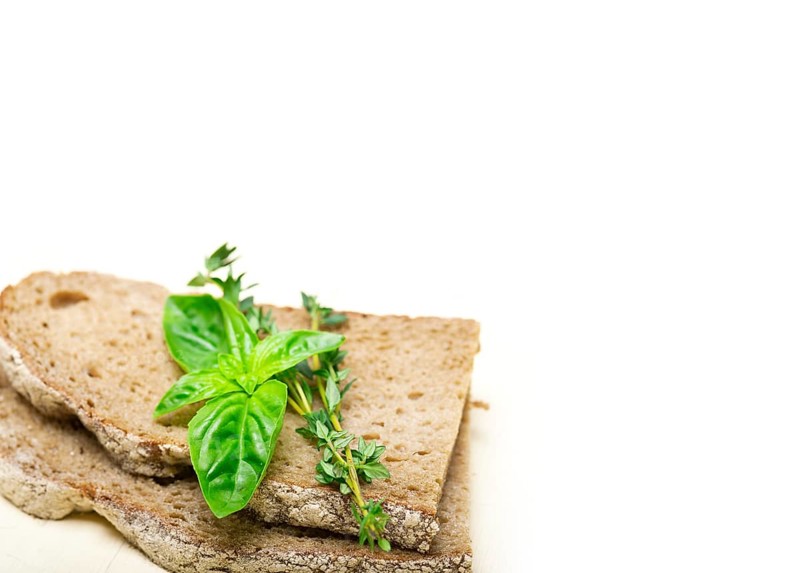 Rustic Italian bread basil and thyme simple snack on white wood table