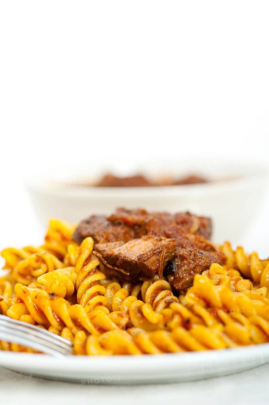 Fusilli pasta al dente with neapolitan style ragu meat sauce very different from bolognese style