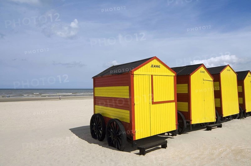 Row of colourful beach cabins on wheels along the North Sea coast at De Panne