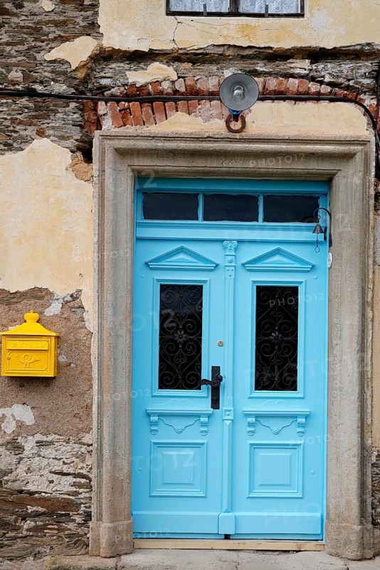 Renovated blue door and yellow letterbox