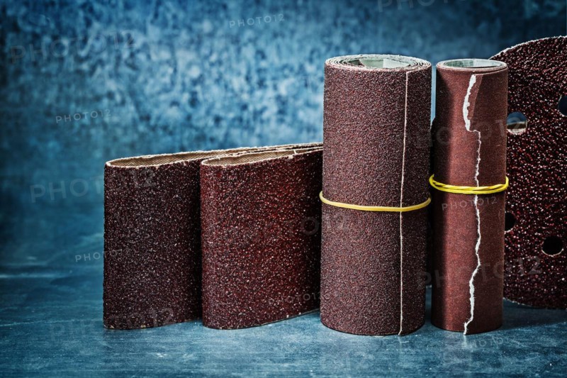 Abrasive tools sanding tapes on metalic background