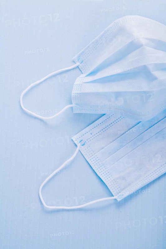 Disposable face masks on a blue background