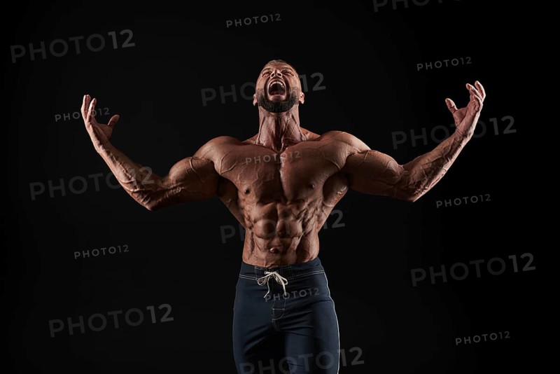 Handsome strong athletic men pumping up muscles. Workout
