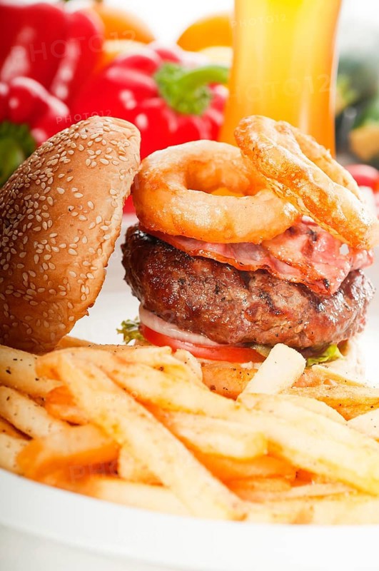 Classic american hamburger sandwich with onion rings and french fries