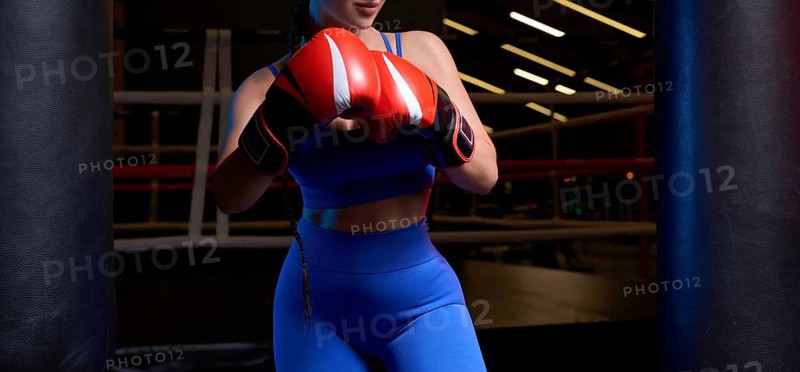 Noname photo of an athletic busty woman in a boxing ring. The concept of sports and mixed martial arts