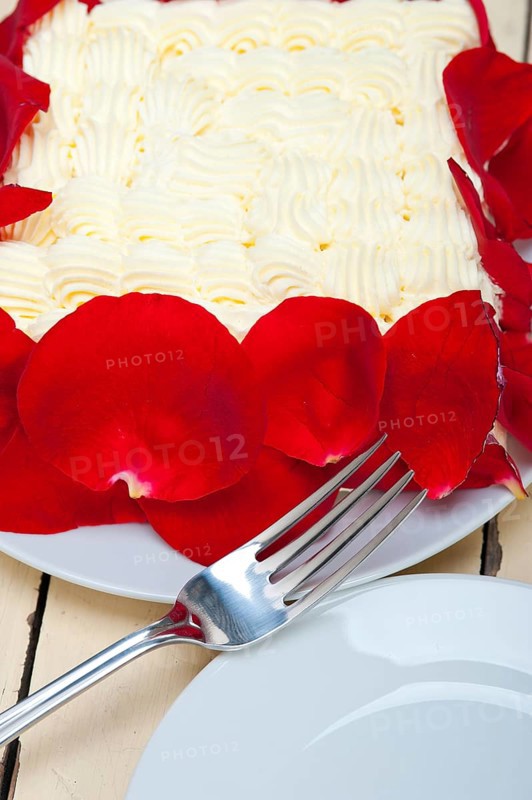 Whipped cream mango cake with red rose petals