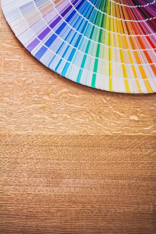 Multi-coloured Pantone fan on wooden board Construction concept
