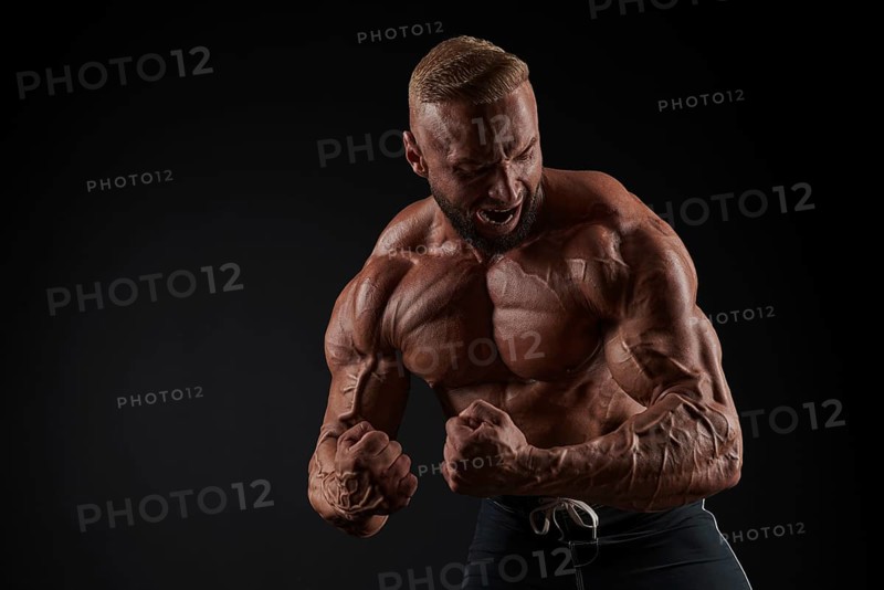 Handsome strong athletic men pumping up muscles. Workout