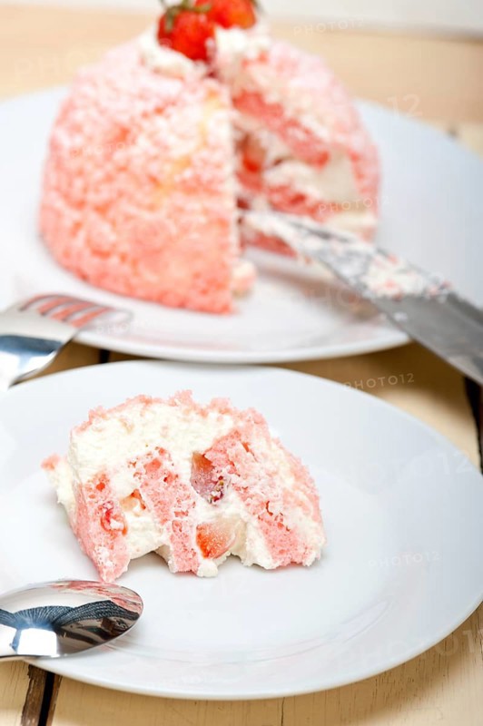 Fresh pink strawberry and whipped cream dessert macro close up