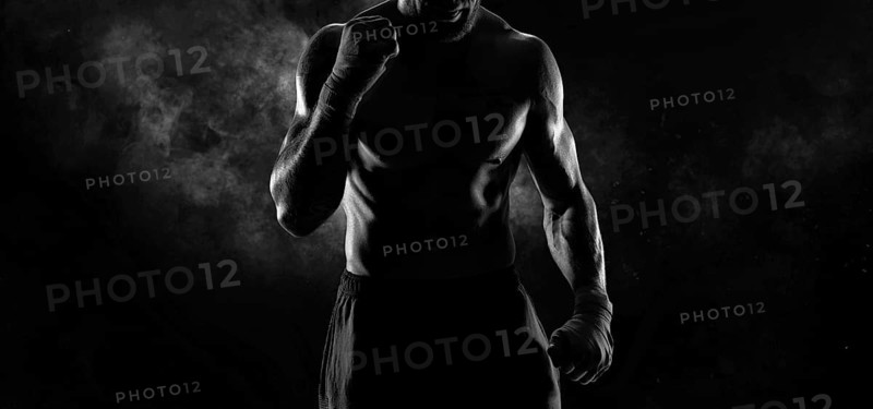 Noname image of a kickboxer on a dark background. The concept of mixed martial arts. MMA