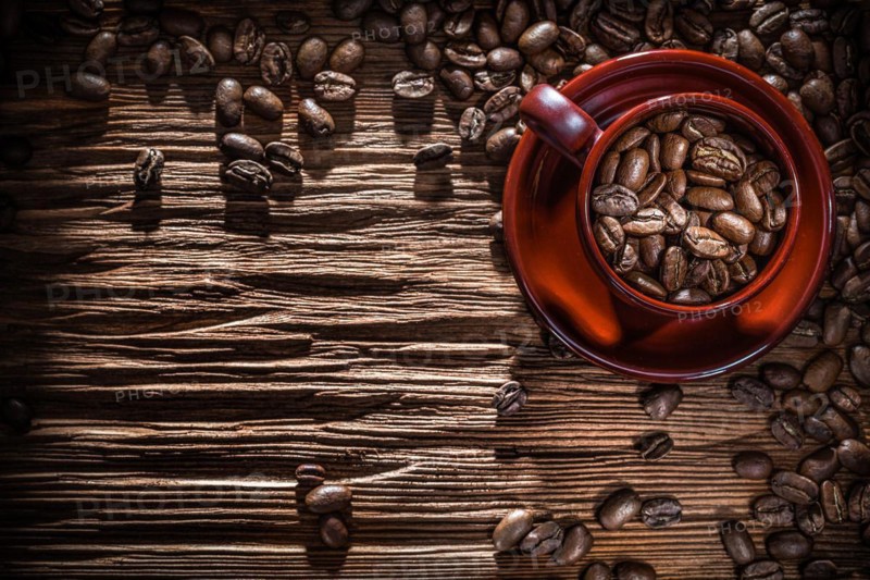 Coffee beans bowl on vintage wooden board