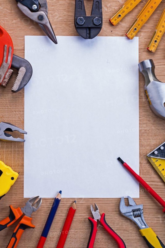 Organised copying surface white paper and cutter metre hammer roller screwdriver pliers pencil tapeline spanner on wooden board