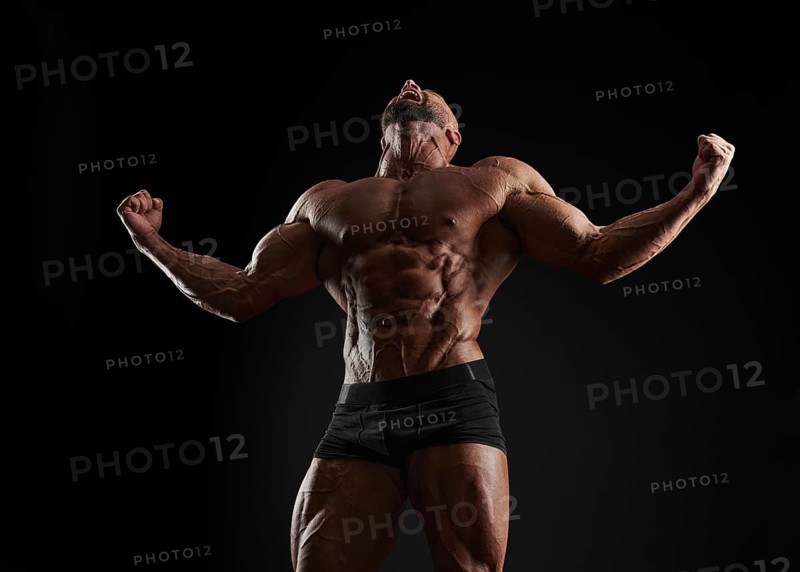 Handsome strong athletic men pumping up muscles. Workout