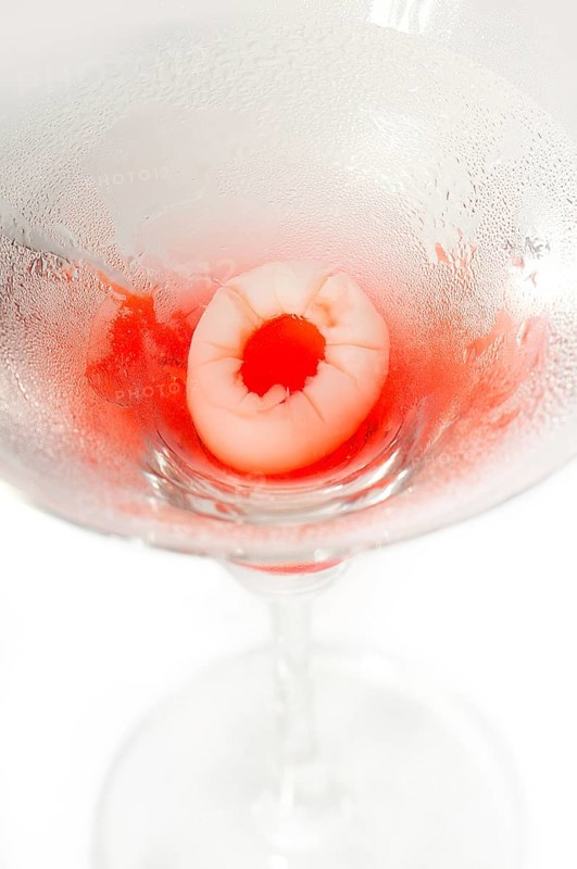 Lychee martini cocktail straight up isolated on white background