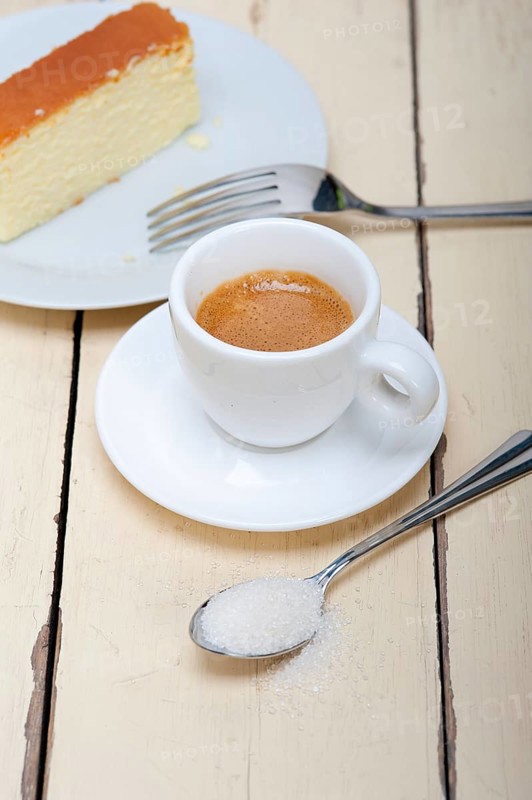 Italian espresso coffee and cheese cake over white wood table