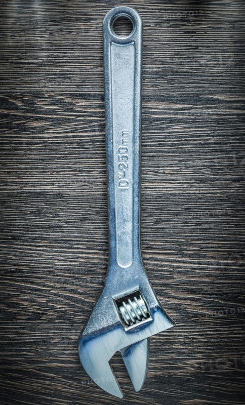 Adjustable spanner on wooden board