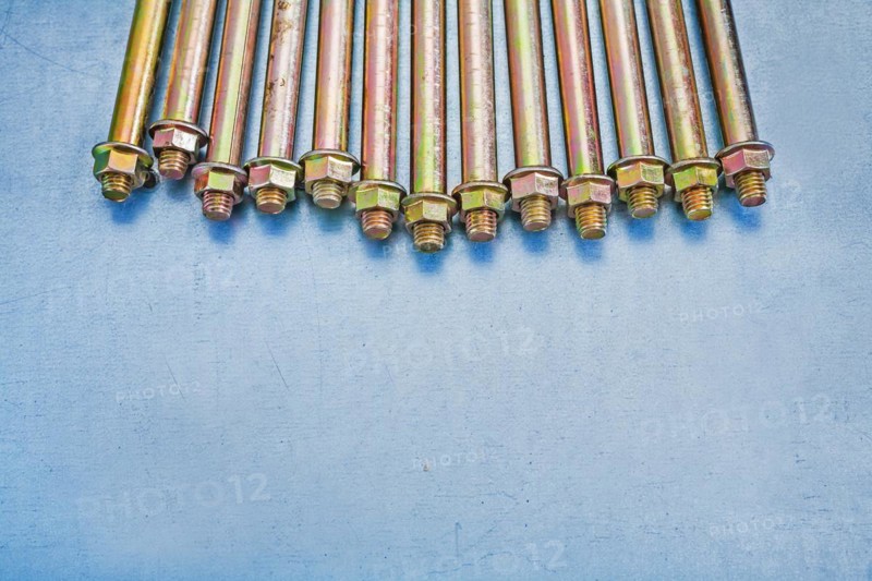 Assembly of anchor bolts for concrete walls with nuts on a metallic substrate Construction concept