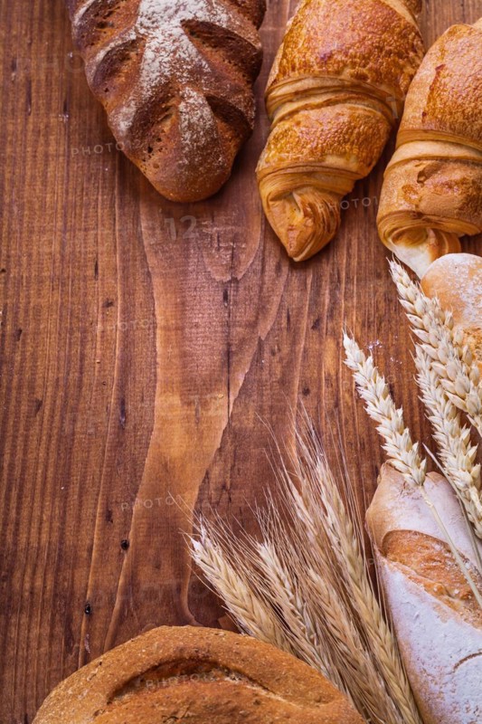 Bread with ears on a wooden background Food and drink Still life