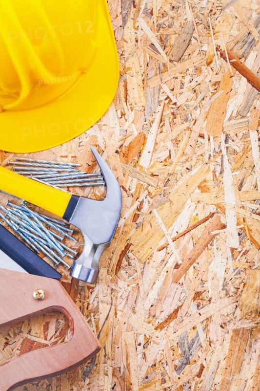Copyspace image set of construction tools helmet claw hammer nails and handsaw on plywood