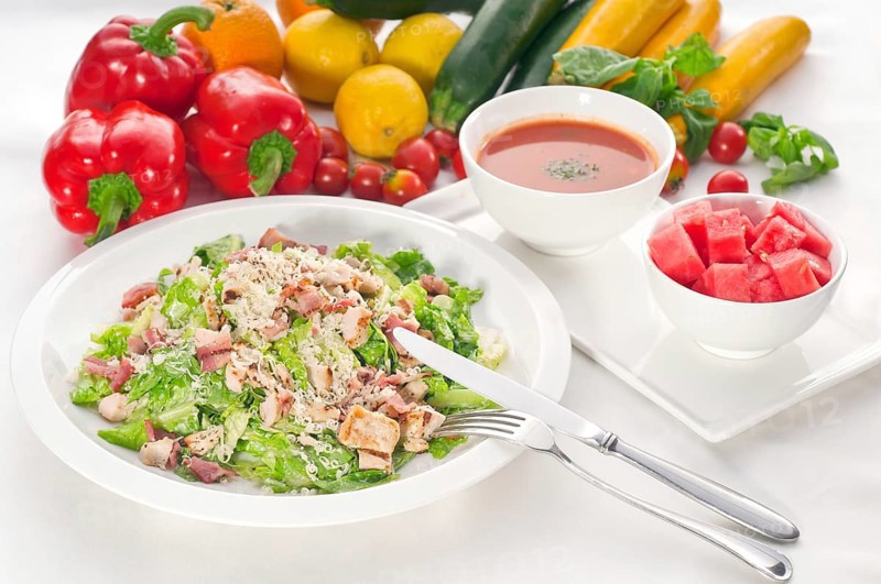 Fresh classic caesar salad served with gazpacho soup