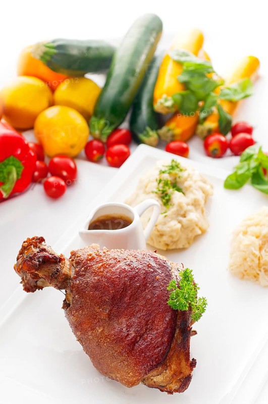 Original German BBQ pork knuckle served with mashed potatoes and sauerkraut
