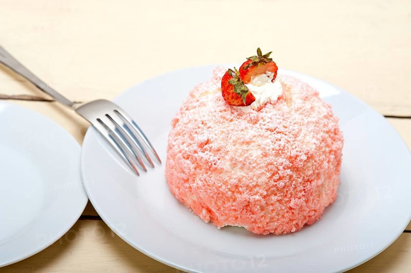 Fresh pink strawberry and whipped cream dessert macro close up