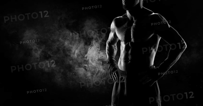 Noname image of a kickboxer on a dark background. The concept of mixed martial arts. MMA