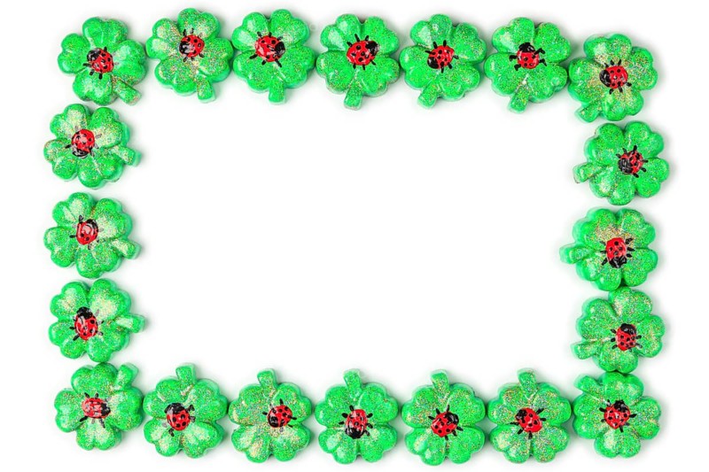 A frame of green shamrocks with ladybirds