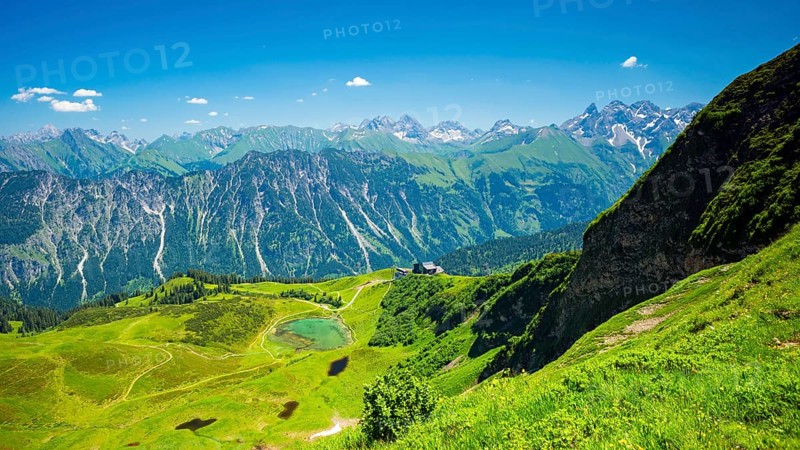 Panorama from the Fellhorn over the Schlappoldsee and Fellhornbahn mountain station to the central main ridge of the Allgaeu Alps