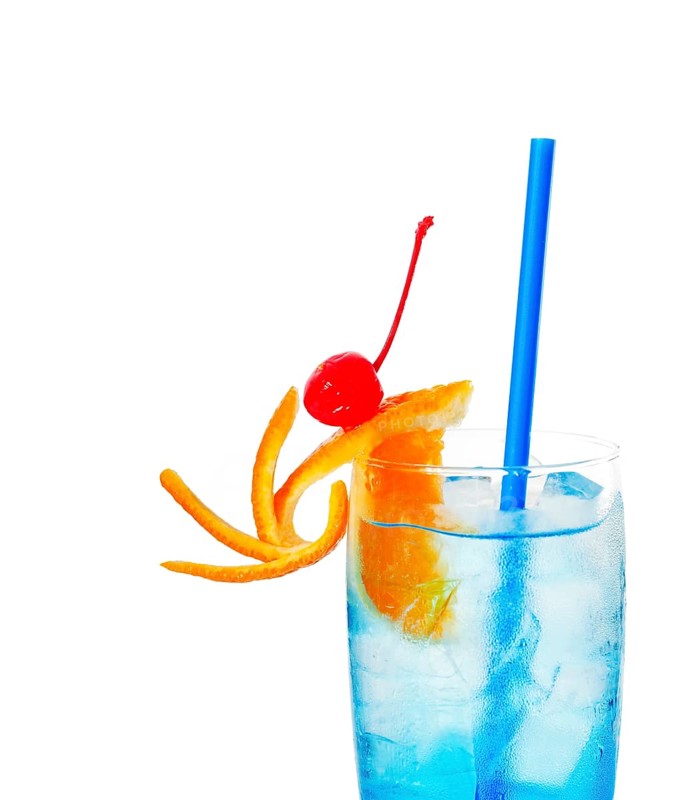 Blue long drink cocktail with orange and cherry garnish and blue straw